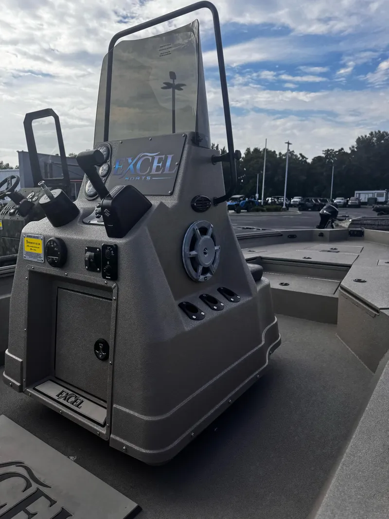 Slide: The Image of 2025 Excel BAY PRO 230 ELITE boat console with steering wheel and controls. - 4