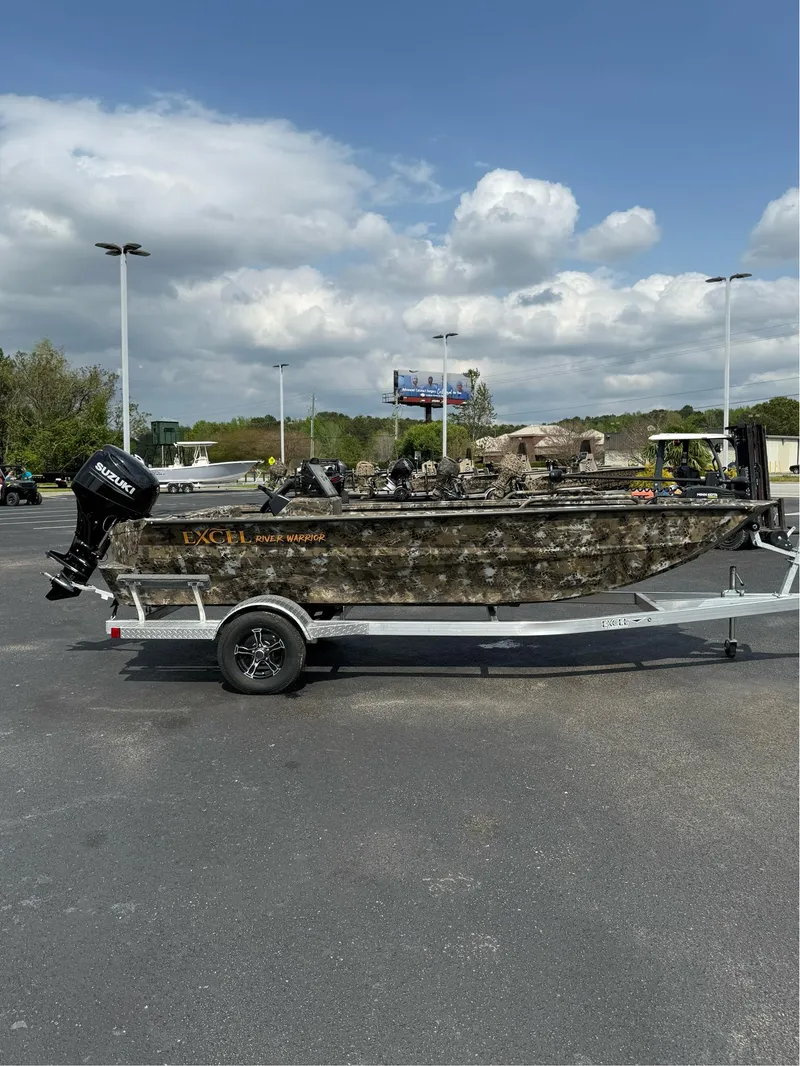 Slide: The Image of 2025 Excel 1751 Side Console River Warrior boat on trailer, parked outdoors. - 10