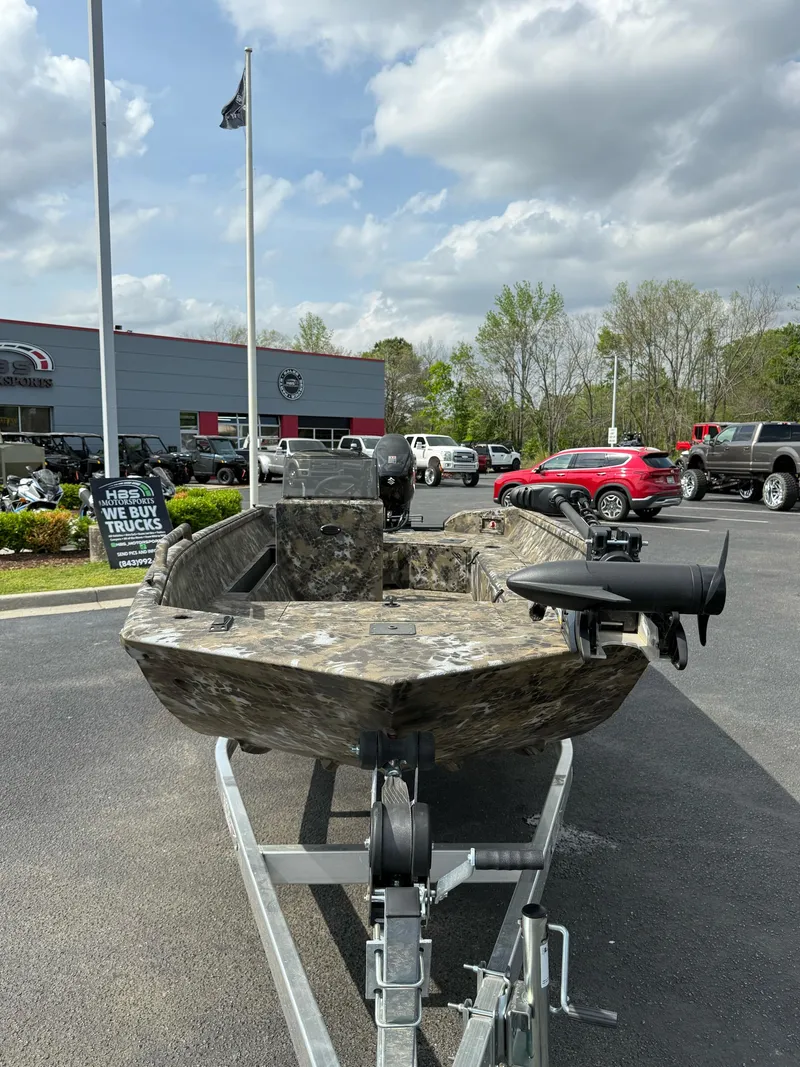 Slide: The Image of 2025 Excel 1751 Side Console River Warrior boat on trailer at dealership. - 15
