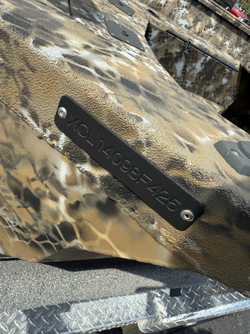 Slide: The Image of 2025 Excel 1751 Side Console River Warrior with camouflage pattern and identification plate. - 17