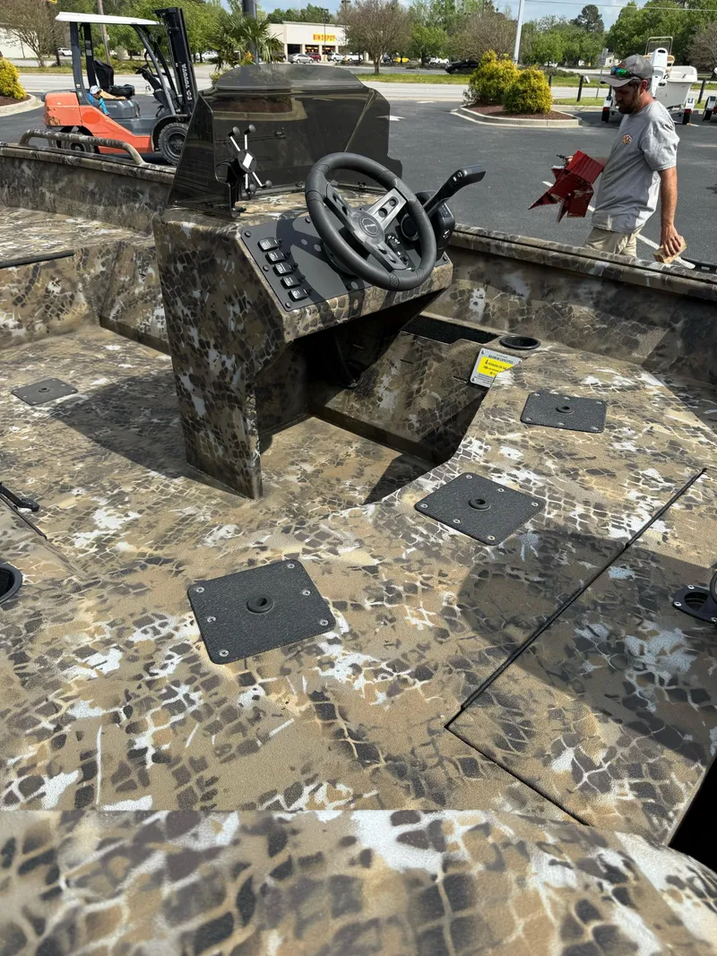 Slide: The Image of 2025 Excel 1751 Side Console River Warrior boat with camouflage design and steering console. - 4