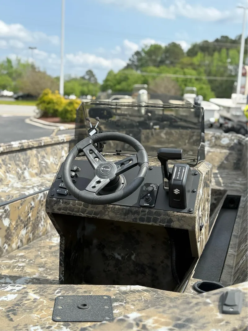 Slide: The Image of 2025 Excel 1751 Side Console River Warrior boat interior with steering wheel and controls. - 8