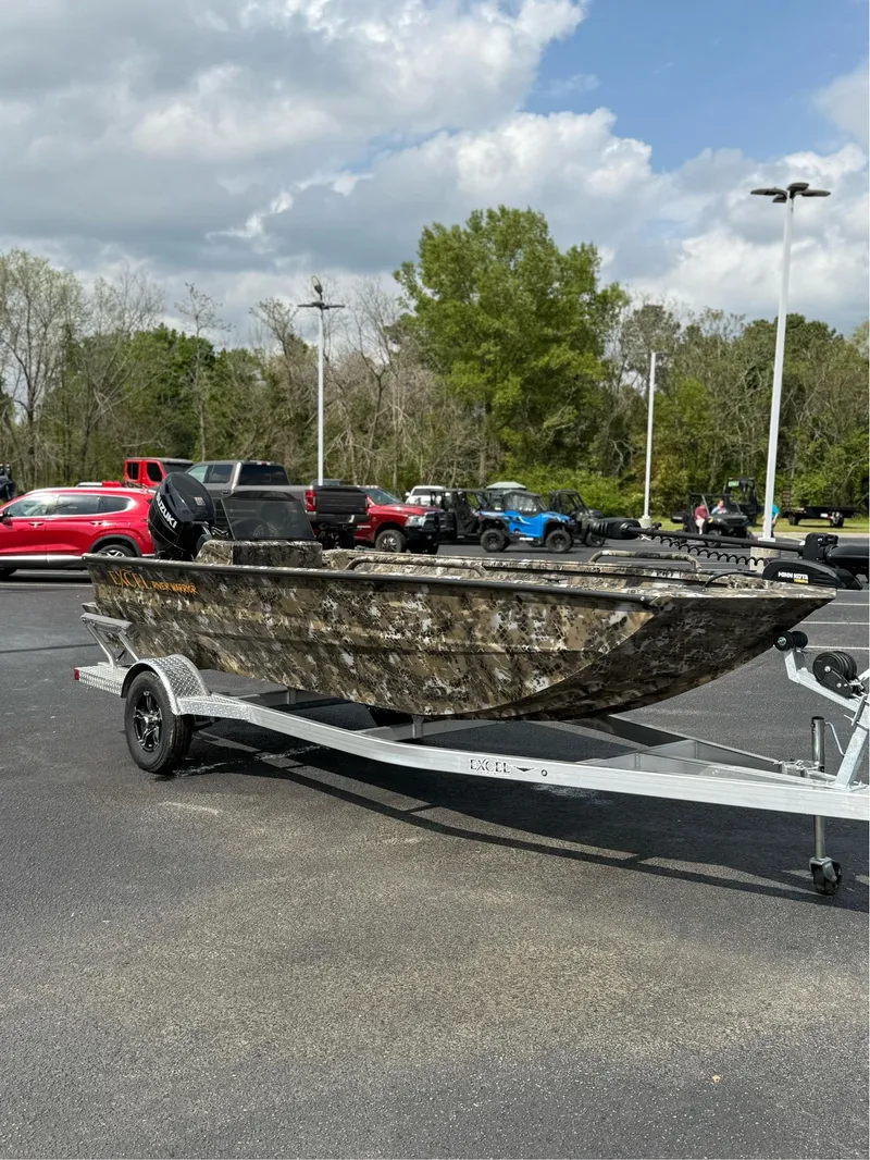 Slide: The Image of 2025 Excel 1751 Side Console River Warrior boat on trailer in parking lot. - 9