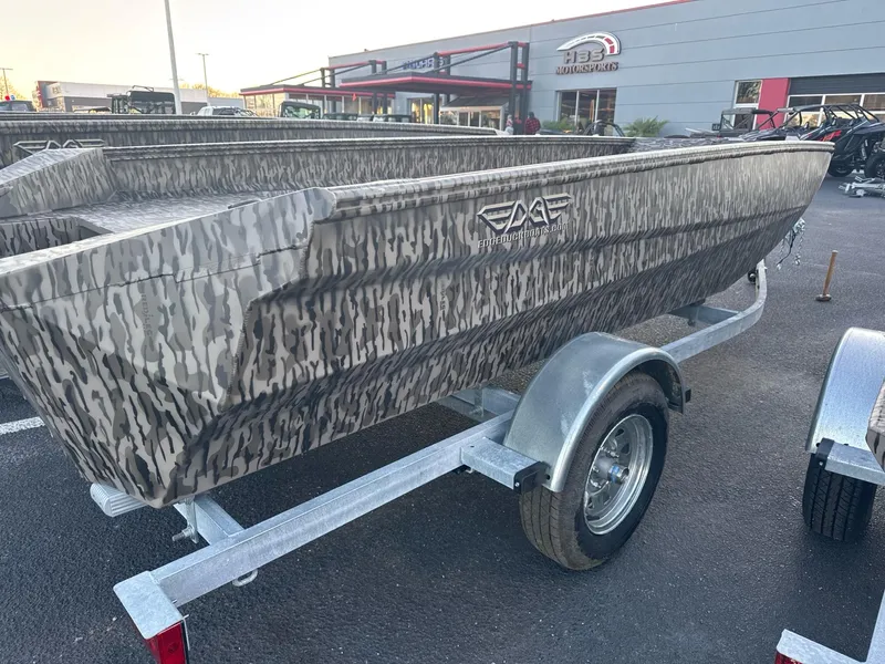 Slide: The Image of 2025 EDGE BOATS 656 SPORTSMAN with camouflage design on a trailer at dealership. - 2