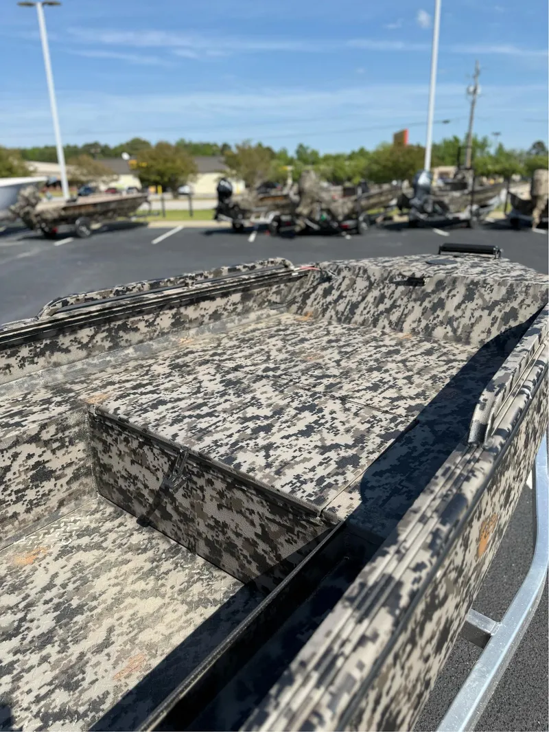 Slide: The Image of Camouflage-patterned EDGE BOATS 653 DB, 2025 model, parked outdoors on a sunny day. - 10