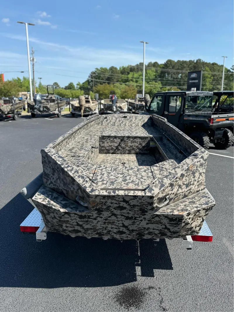 Slide: The Image of 2025 EDGE BOATS 653 DB camo-pattern boat on trailer in parking lot. - 4