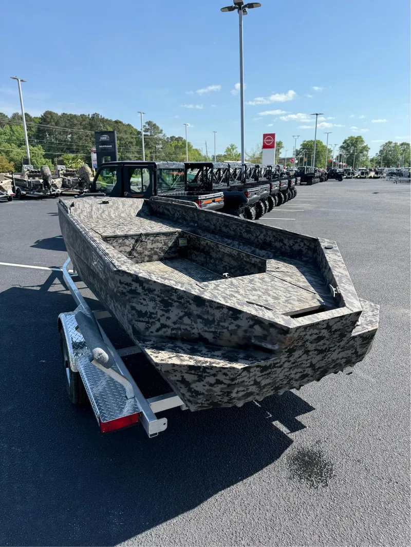 Slide: The Image of 2025 EDGE BOATS 653 DB camo boat on trailer in parking lot. - 5