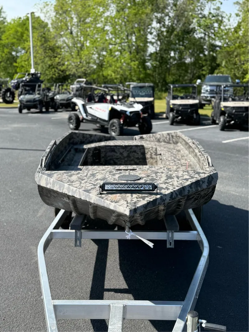 Slide: The Image of 2025 EDGE BOATS 653 DB on trailer, surrounded by off-road vehicles. - 7