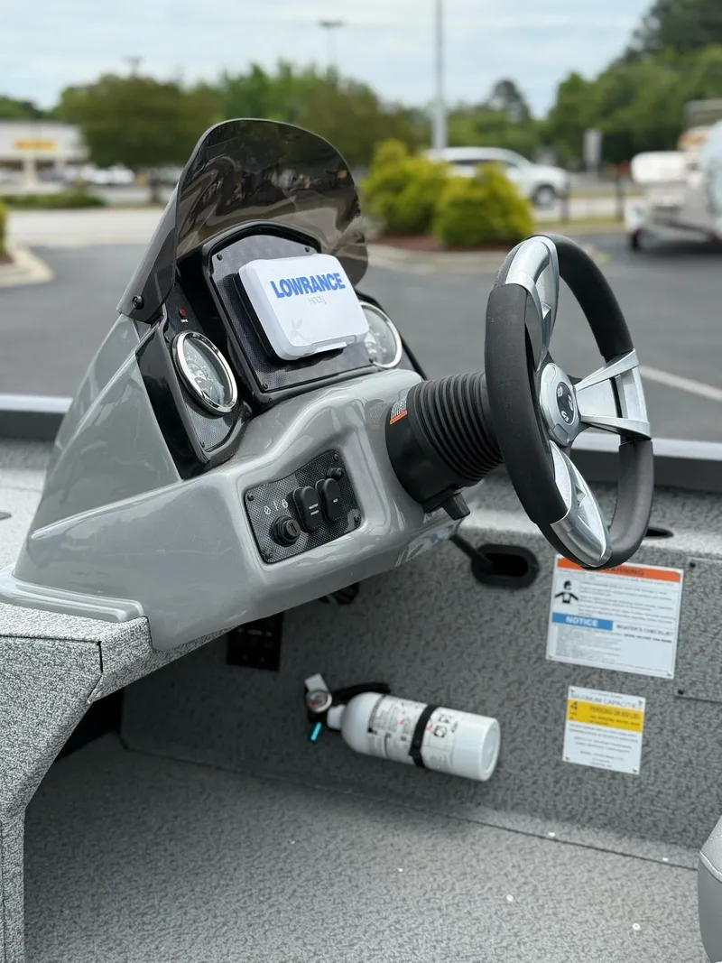 Slide: The Image of 2021 G3 Sportsman 1710 boat dashboard with steering wheel and Lowrance device. - 15