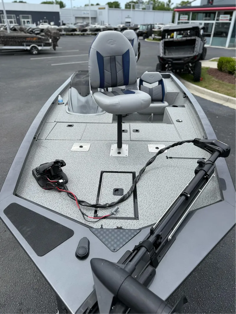 Slide: The Image of 2021 G3 Sportsman 1710 fishing boat with seating and trolling motor, parked outdoors. - 3