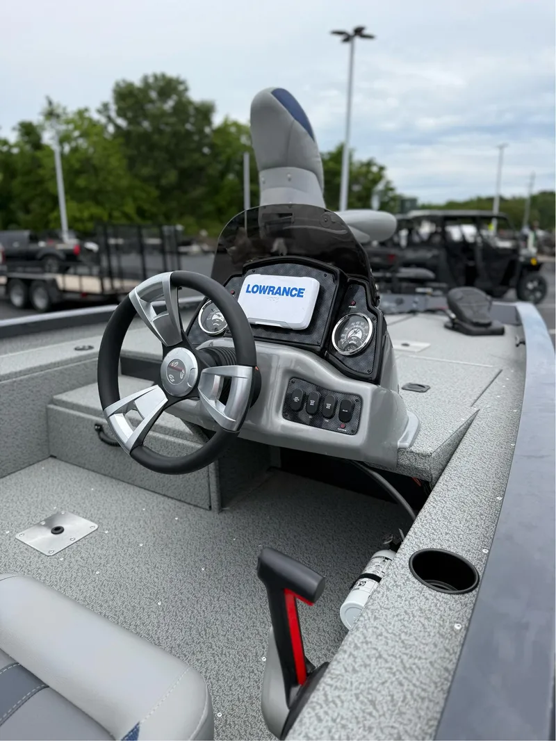 Slide: The Image of 2021 G3 Sportsman 1710 boat interior with steering wheel and Lowrance display. - 7