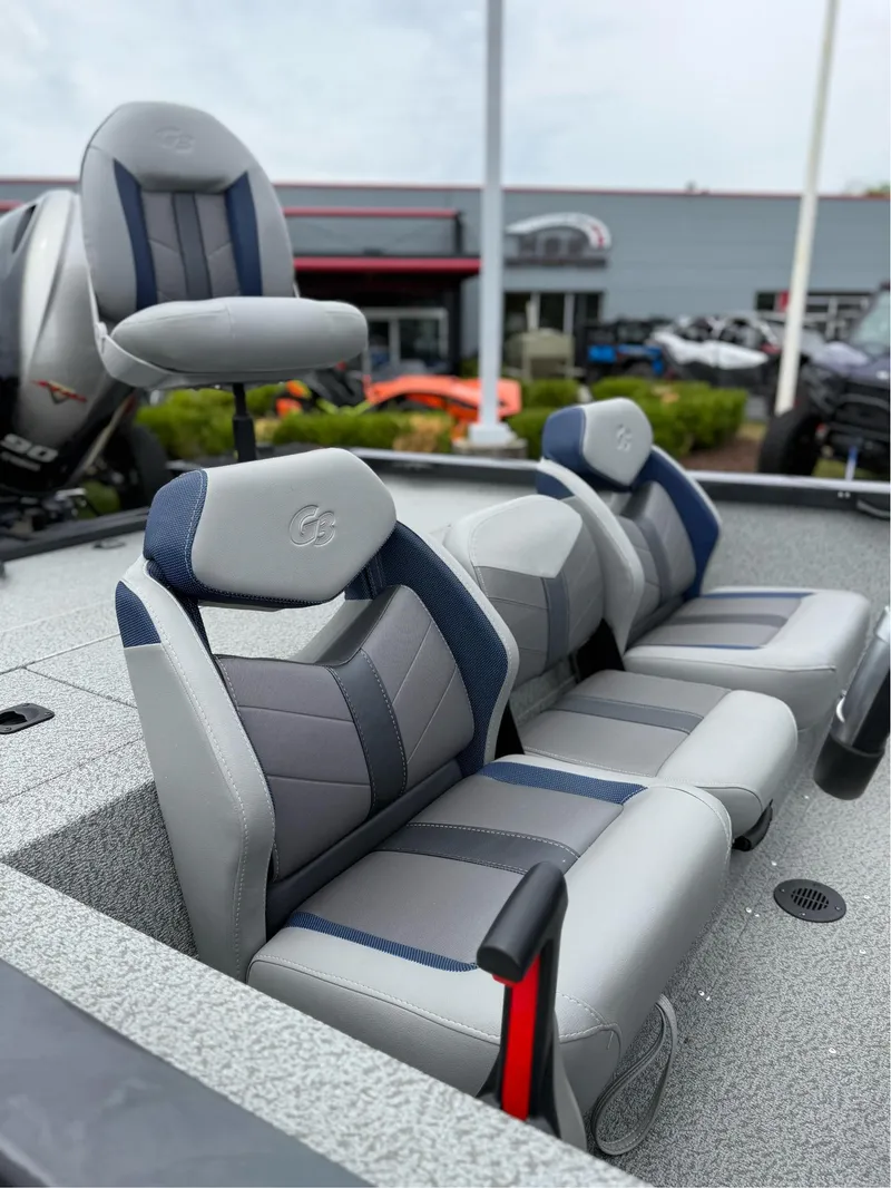Slide: The Image of 2021 G3 Sportsman 1710 boat seats, gray and blue upholstery, outdoor showroom display. - 8