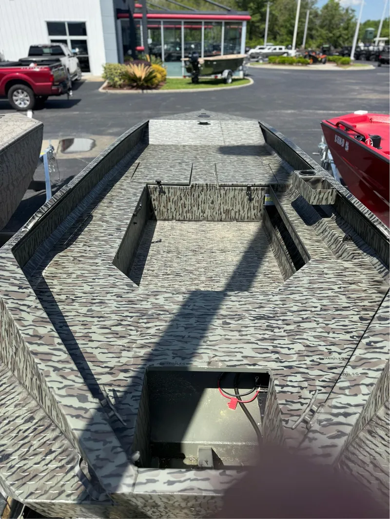 Slide: The Image of 2025 EDGE BOATS 556DB with camouflage design, displayed outdoors at a dealership. - 5