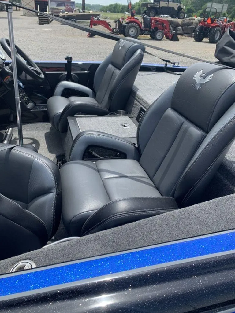 Slide: The Image of 2024 Phoenix Bass Boats 518 Pro interior with black leather seats and steering wheel. - 4