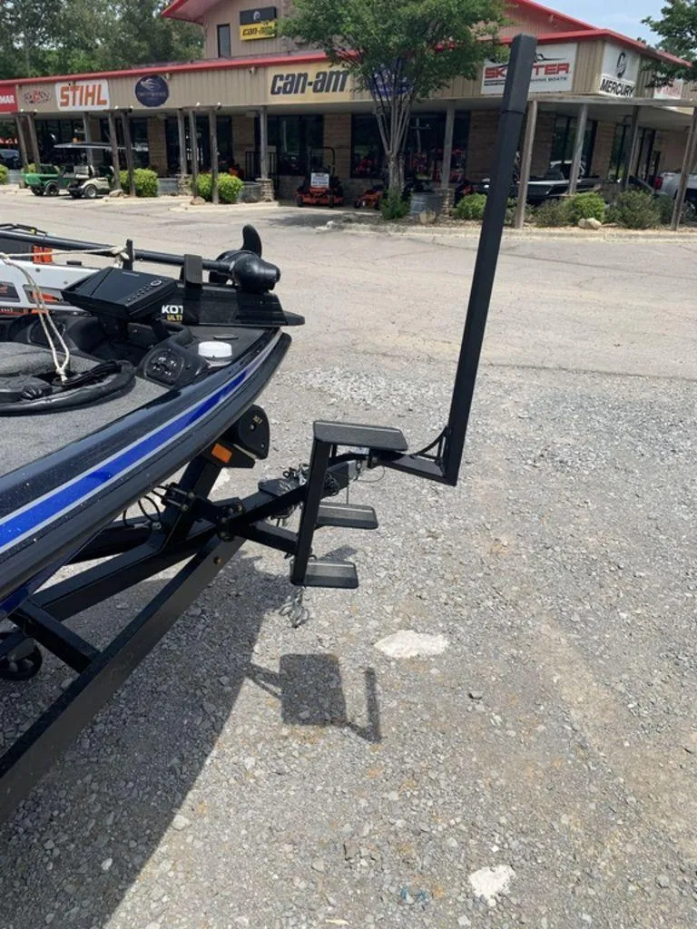 Slide: The Image of 2024 Phoenix Bass Boats 518 Pro at dealership, featuring trailer and accessories. - 8