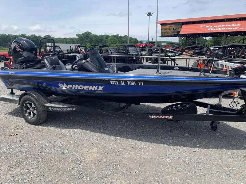 Slide: The Image of 2024 Phoenix Bass Boats 518 Pro in blue, parked outdoors on a trailer. - 9