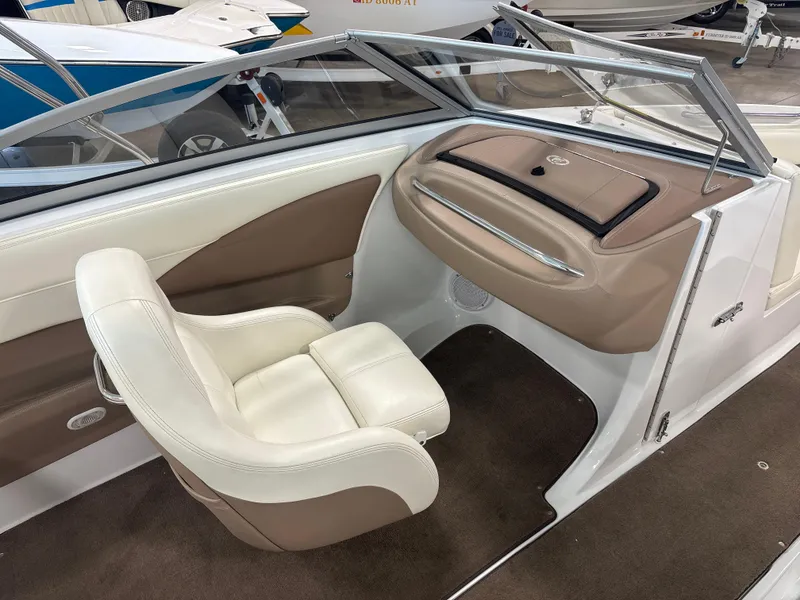 Slide: The Image of 2008 Cobalt 202 boat interior with white and beige seating, dashboard, and windshield. - 11