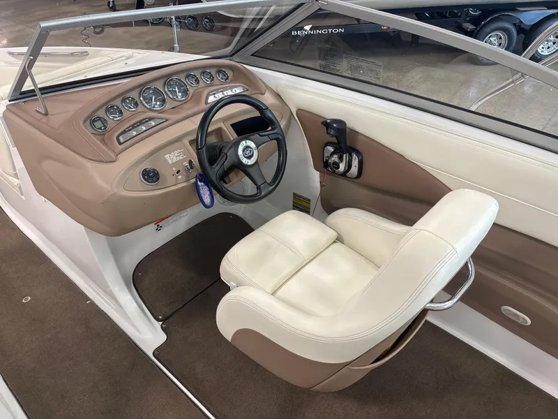 Slide: The Image of 2008 Cobalt 202 boat interior with steering wheel and beige seating. - 12