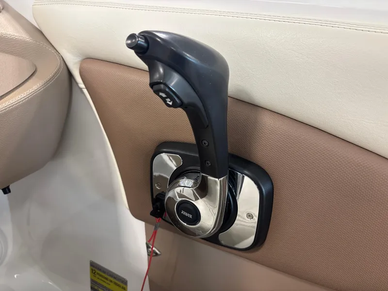 Slide: The Image of Boat throttle control lever in a 2008 Cobalt 202, featuring beige and brown interior. - 17