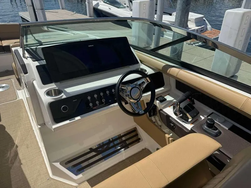 Slide: The Image of 2023 Sea Ray SLX 310 helm with modern controls and sleek design. - 3
