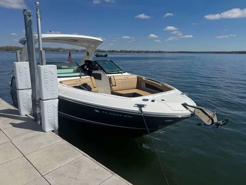 Slide: The Image of 2023 Sea Ray SLX 310 boat docked on a sunny day, calm waters. - 4