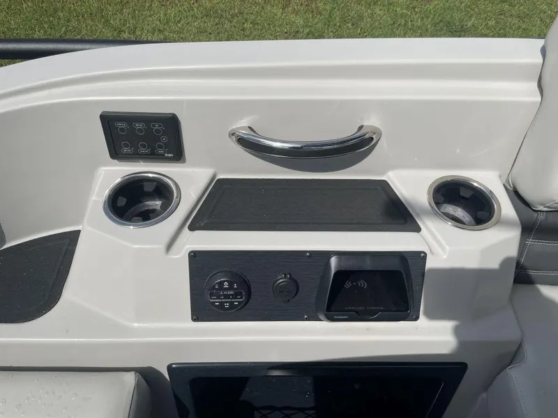 Slide: The Image of Control panel of 2025 Sylvan G-3 DLZ DH boat with cup holders and wireless charging. - 14
