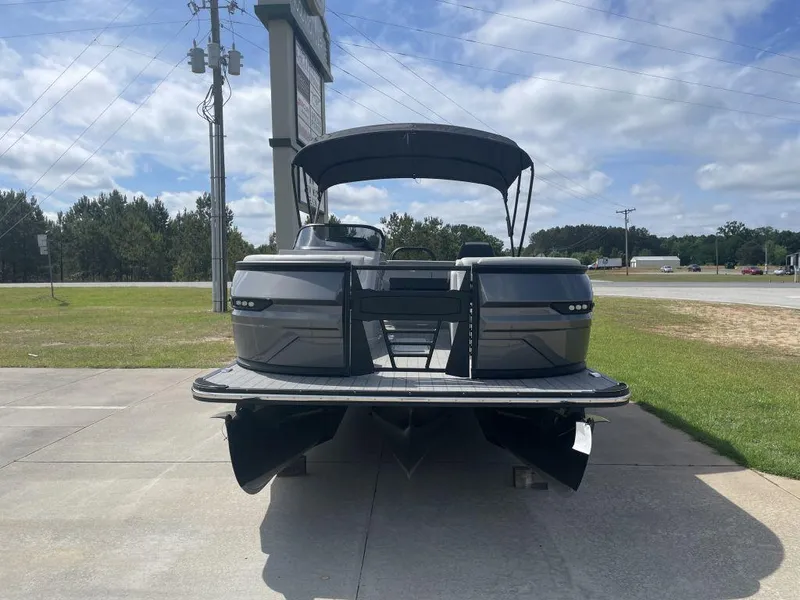 Slide: The Image of 2025 Sylvan G-3 DLZ DH pontoon boat on display, front view, sunny day. - 2
