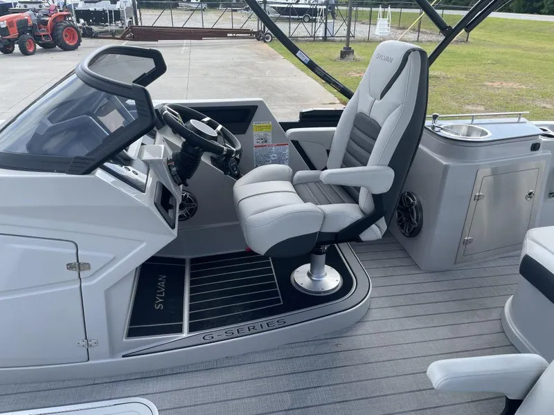 Slide: The Image of 2025 Sylvan G-3 DLZ DH boat interior with captain's chair and control panel. - 21
