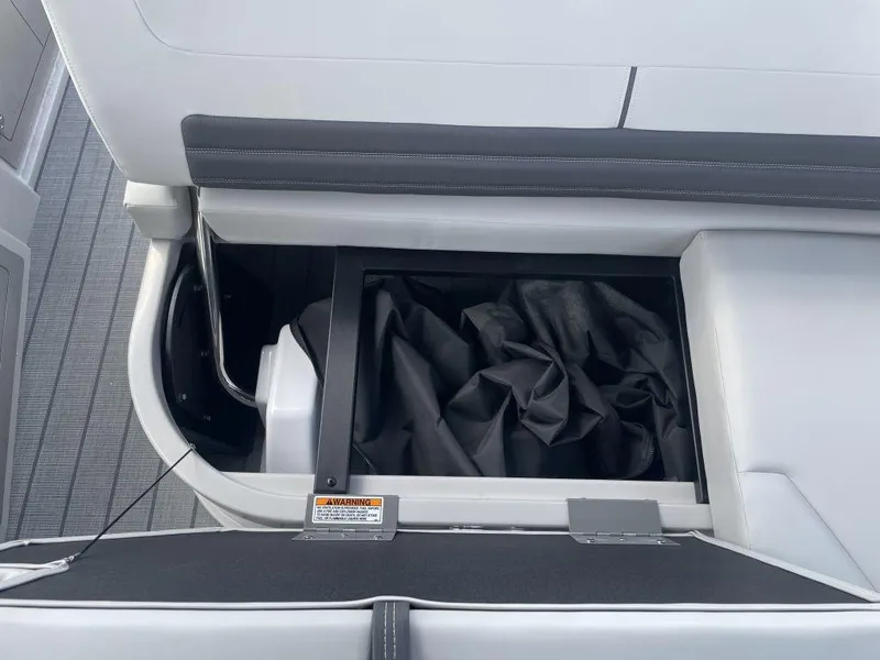 Slide: The Image of Interior storage compartment of 2025 Sylvan G-3 DLZ DH boat with black cover. - 23