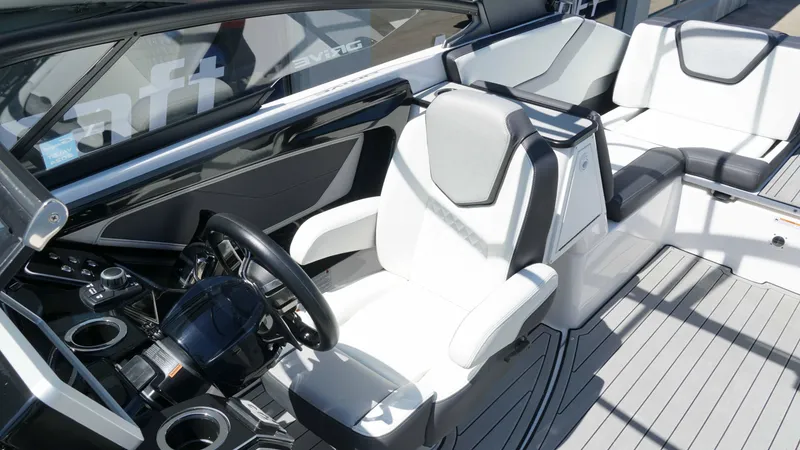 Slide: The Image of 2021 Yamaha Boats 252SD interior with sleek white and gray seating and modern dashboard. - 14
