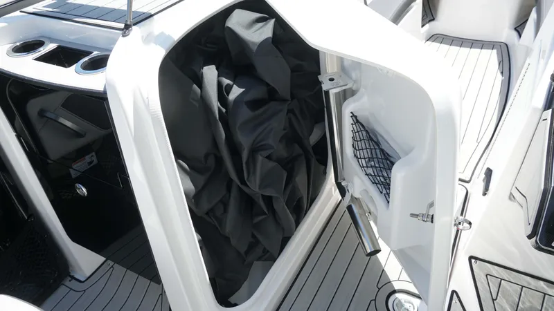 Slide: The Image of 2021 Yamaha Boats 252SD storage compartment with open door and interior view. - 18