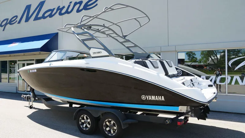 Slide: The Image of 2021 Yamaha Boats 252SD on trailer outside dealership, showcasing sleek design and modern features. - 3