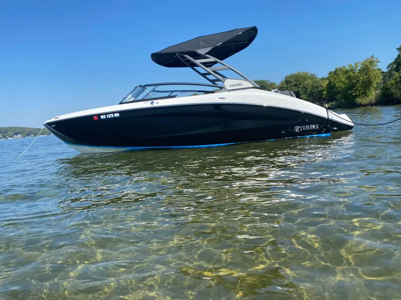 Slide: The Image of 2021 Yamaha Boats 252SD on clear water, under a blue sky. - 4
