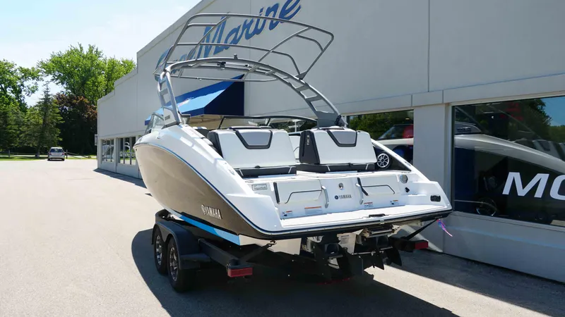 Slide: The Image of 2021 Yamaha Boats 252SD on trailer outside dealership, showcasing sleek design and modern features. - 5