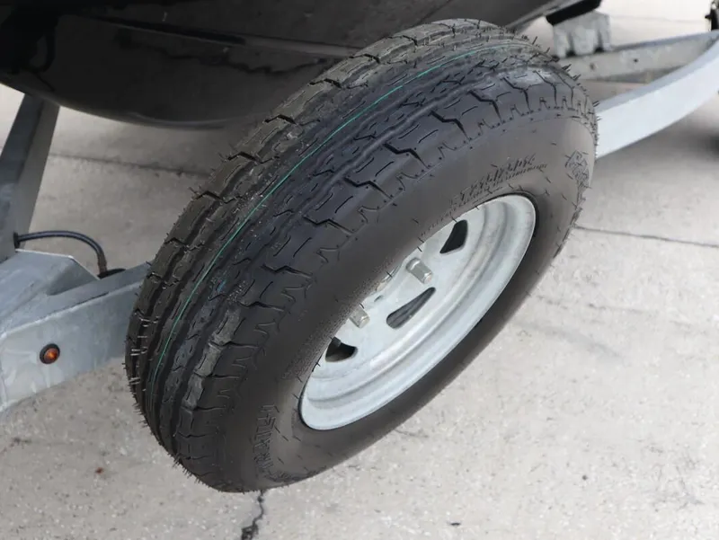Slide: The Image of Trailer tire for 2019 Yamaha Boats SX195 on concrete surface. - 10