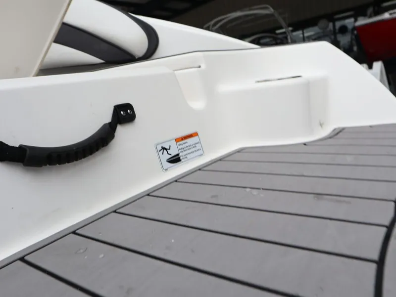 Slide: The Image of 2019 Yamaha Boats SX195 interior detail with handle and warning label. - 16