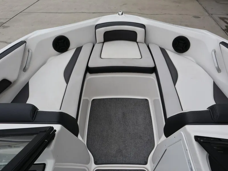 Slide: The Image of 2019 Yamaha Boats SX195 interior with cushioned seating and speakers. - 18