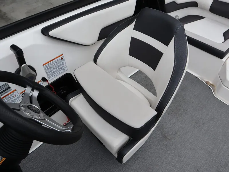 Slide: The Image of 2019 Yamaha Boats SX195 interior with black and white seating and steering wheel. - 20