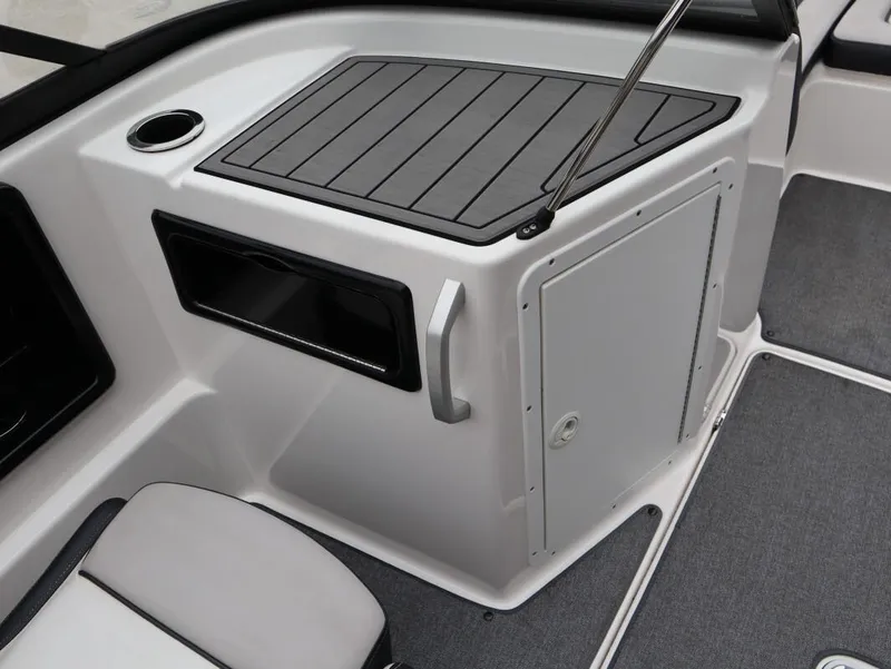 Slide: The Image of 2019 Yamaha SX195 boat interior with storage compartment and cup holder. - 24