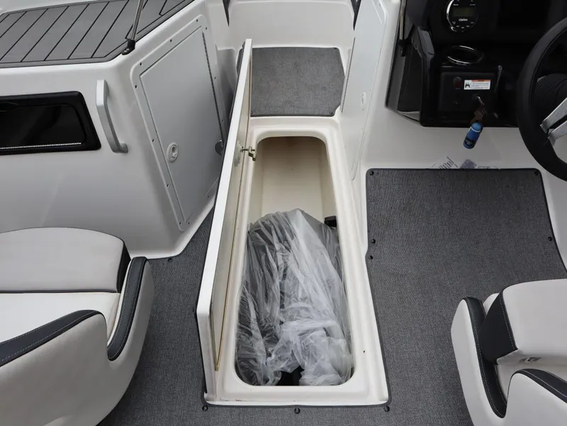 Slide: The Image of 2019 Yamaha SX195 boat interior storage compartment with open hatch and seating. - 25