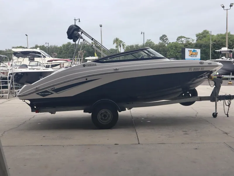 Slide: The Image of 2019 Yamaha SX195 boat on trailer at marina, side view. - 3