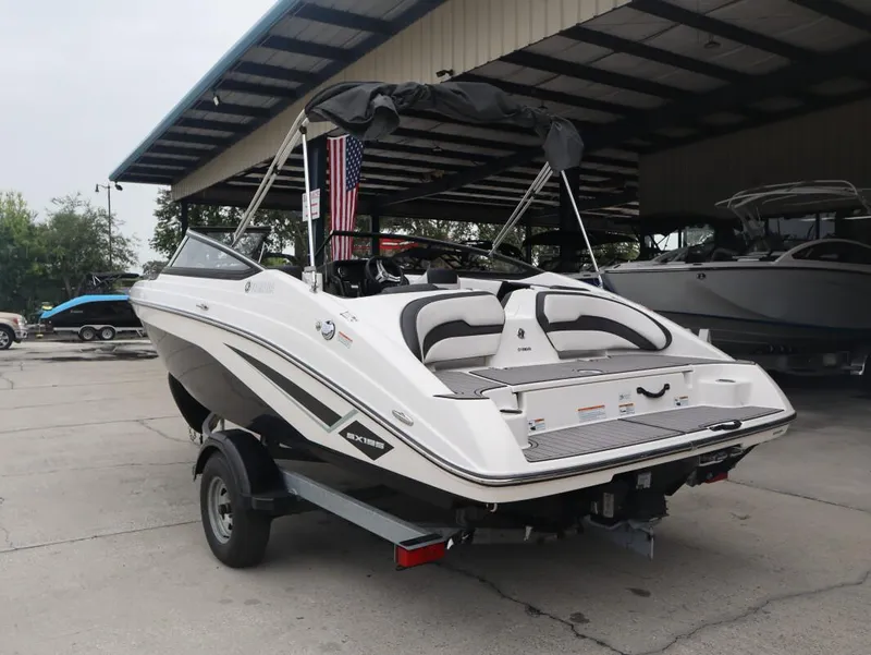 Slide: The Image of 2019 Yamaha Boats SX195 in a covered marina, rear view. - 6