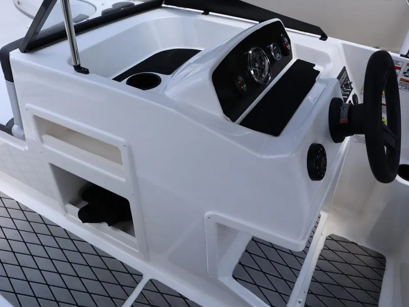 Slide: The Image of 2023 Bayliner Element M17 boat dashboard with steering wheel and controls. - 18