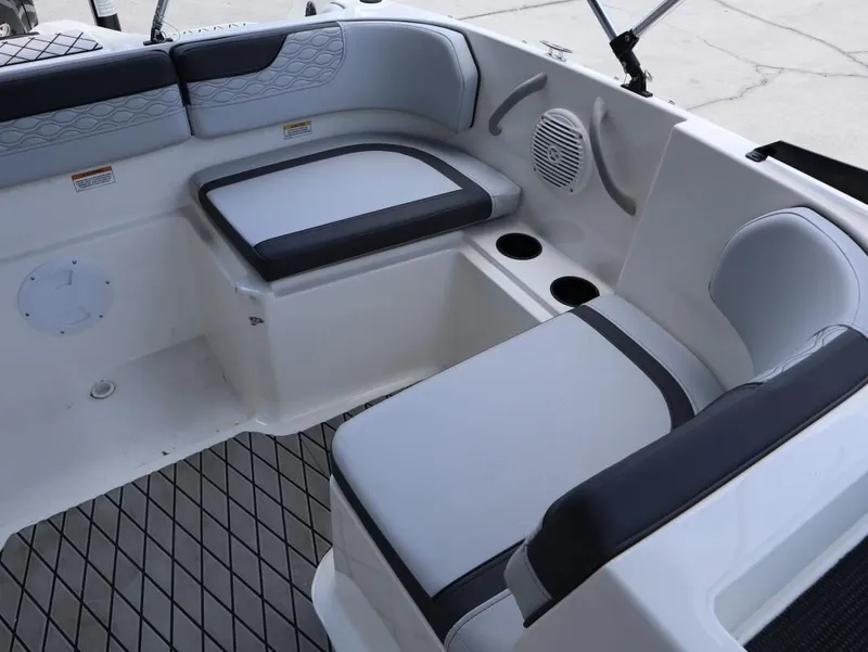 Slide: The Image of 2023 Bayliner Element M17 boat interior with cushioned seating and cup holders. - 22