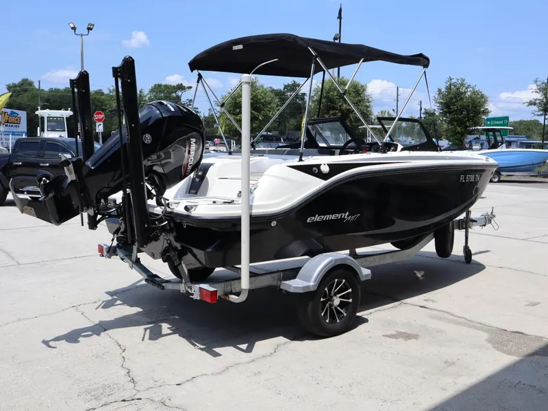 Slide: The Image of 2023 Bayliner Element M17 boat on trailer, black and white design, outdoor display. - 3