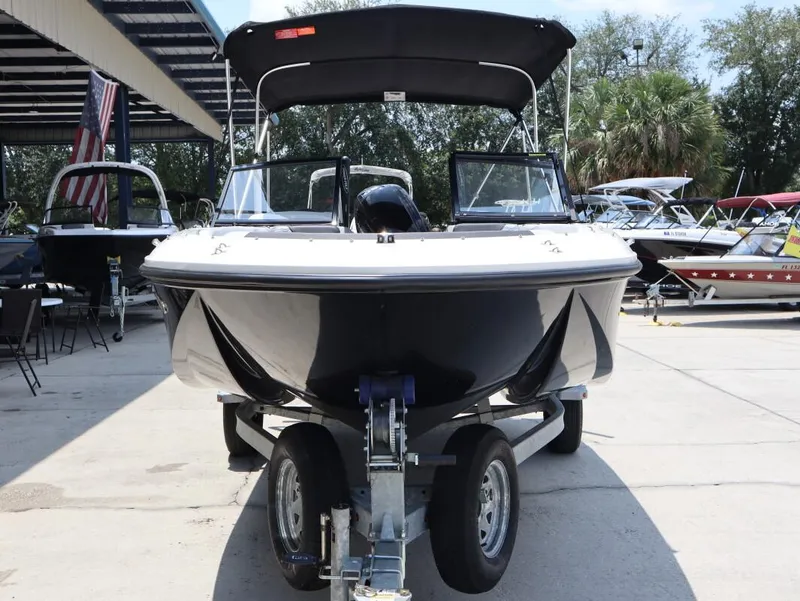 Slide: The Image of 2023 Bayliner Element M17 boat on trailer, displayed outdoors. - 4