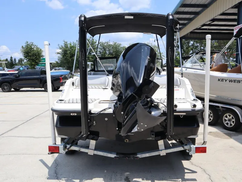 Slide: The Image of 2023 Bayliner Element M17 boat rear view with outboard motor in a marina. - 5