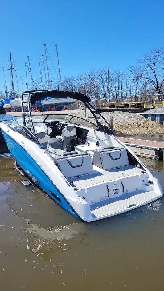 Slide: The Image of 2023 Yamaha Boats AR250 in water, showcasing sleek design and spacious seating. - 10