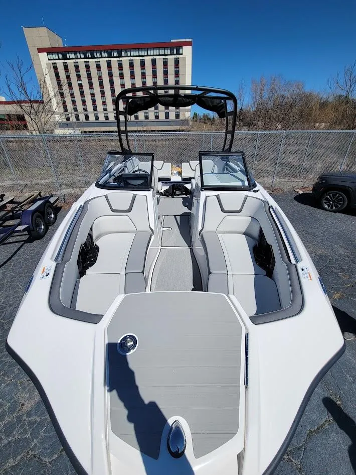 Slide: The Image of 2023 Yamaha Boats AR250 with sleek design and spacious seating, parked outdoors. - 5