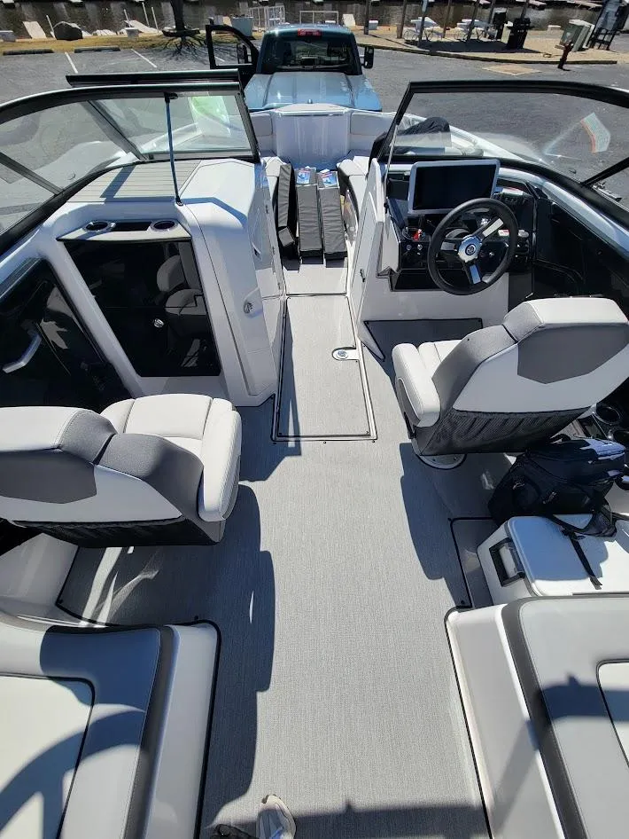 Slide: The Image of 2023 Yamaha Boats AR250 interior with modern seating and steering console. - 9